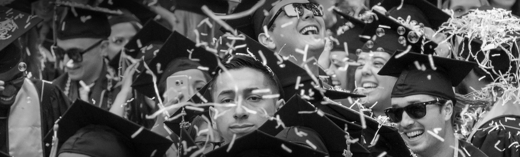 Students celebrating graduation with confetti